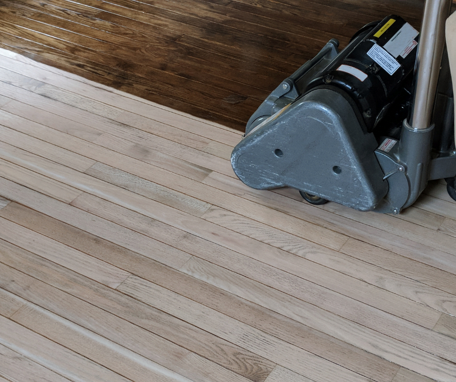 Sanding machine on unfinished hardwood floor
